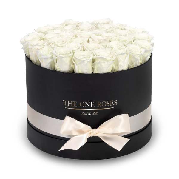 Round box of white roses with a satin ribbon