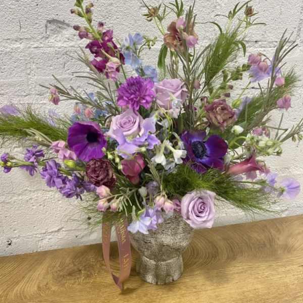 Lavender and purple mixed bouquet in a textured vase