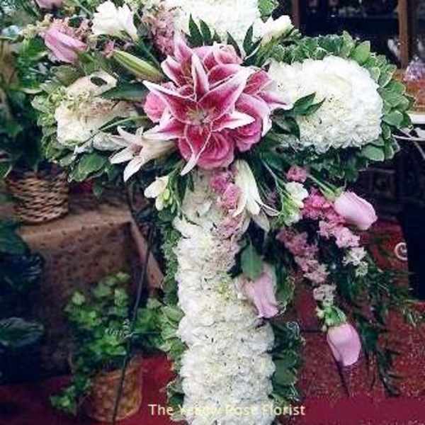 Large pink and white floral cross arrangement with lilies and hydrangeas