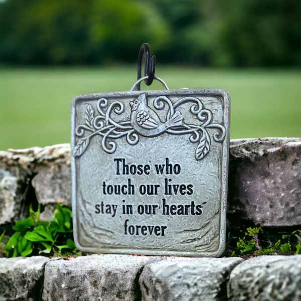 Memorial plaque with a bird and the words "Those who touch our lives stay in our hearts forever"