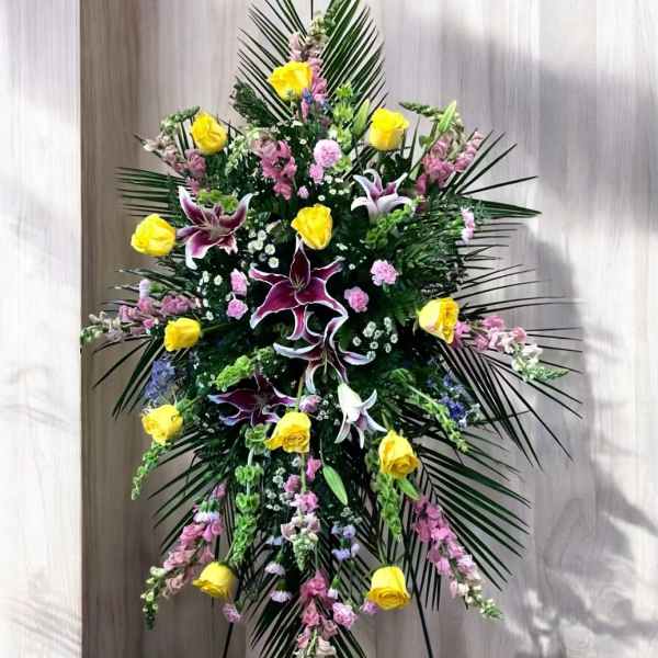 Tall floral standing spray with yellow roses and purple lilies