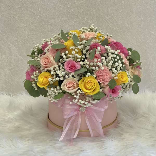 Pink hatbox arrangement with roses, carnations, and baby's breath