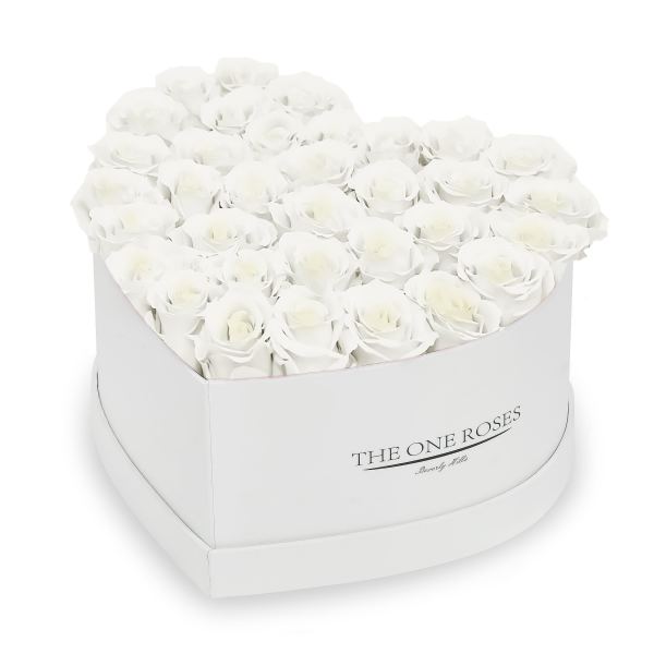 White roses arranged in a round white hat box