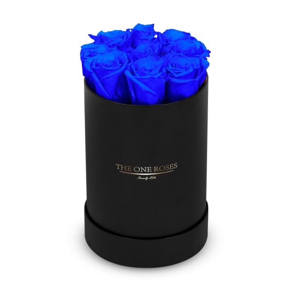 Blue roses arranged in a black round box