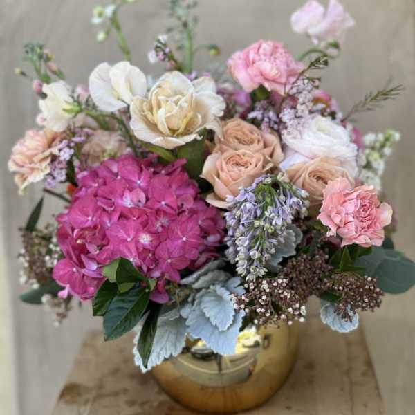 Mixed pink and cream bouquet in a gold vase