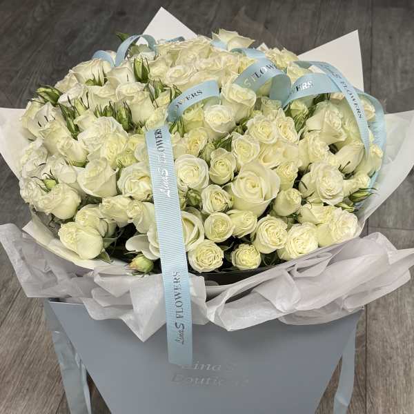 Large bouquet of white roses in a pale blue gift box