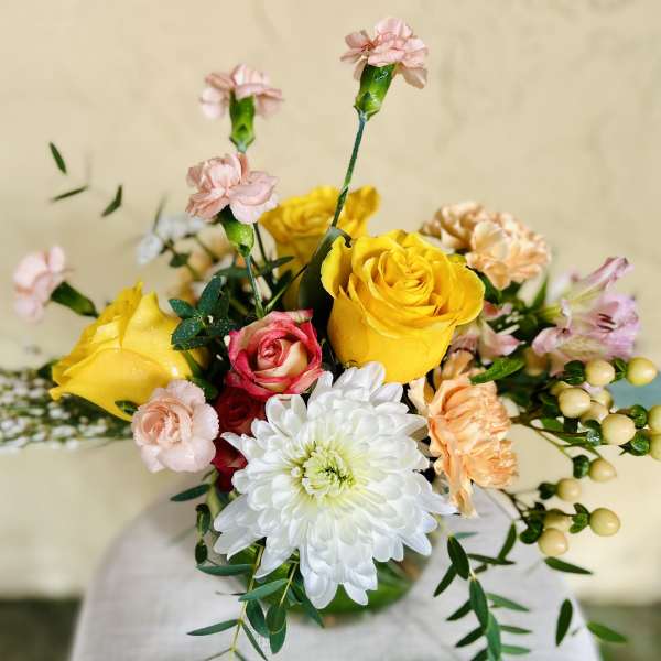 Bouquet of yellow and pink roses with white chrysanthemum and carnations