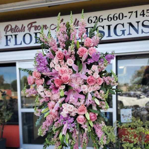 Large pink floral standing spray on an easel