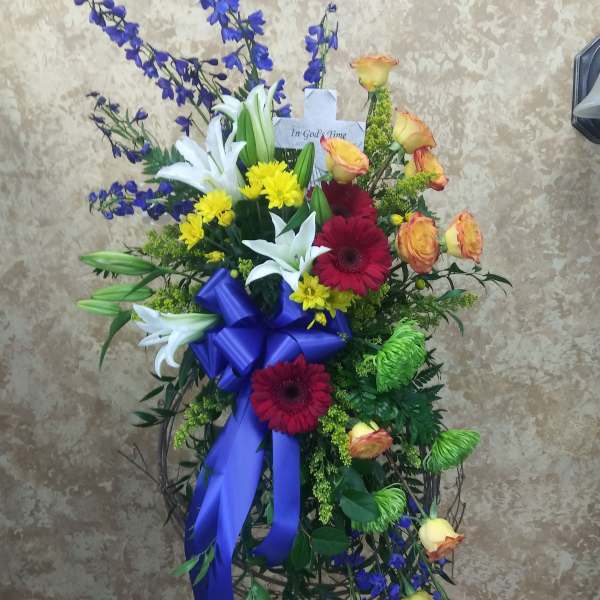 Standing sympathy spray with lilies, roses, and gerbera daisies
