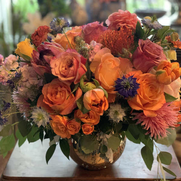 Bright orange and pink bouquet in a glass vase