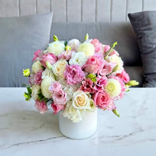 Pink and white bouquet in a white vase