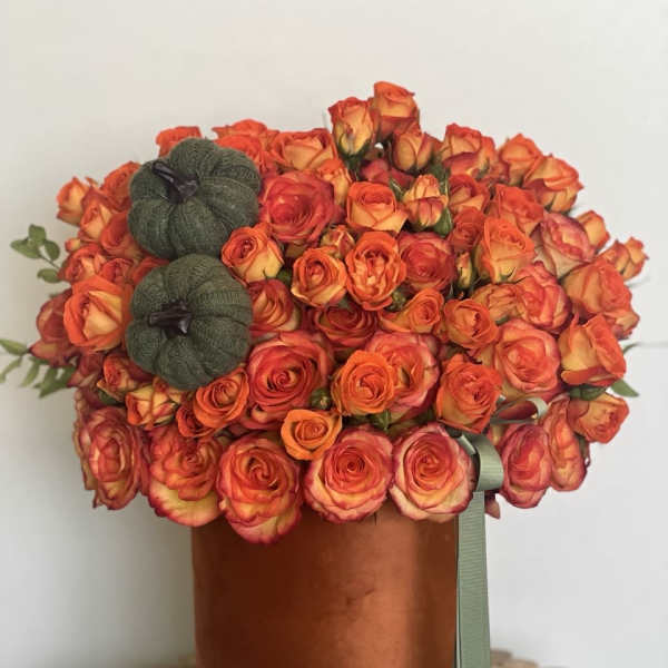 Orange rose bouquet in a copper hatbox with two small pumpkins