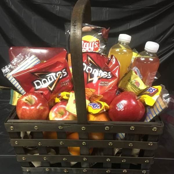 Gift basket with chips, apples, oranges, and bottled drinks