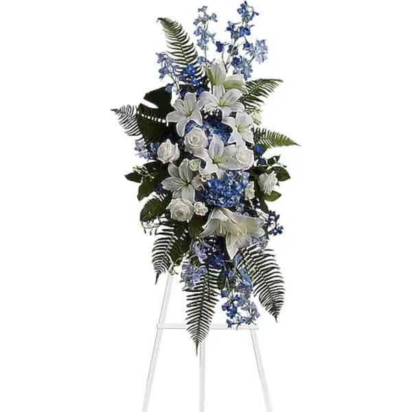 White and blue floral standing spray on an easel