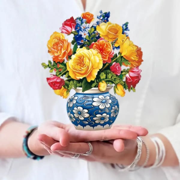 Colorful bouquet of roses in a blue floral vase