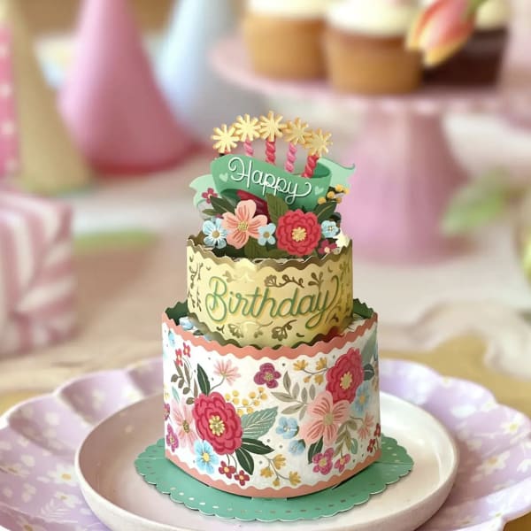 Tiered birthday card with floral decorations on a plate