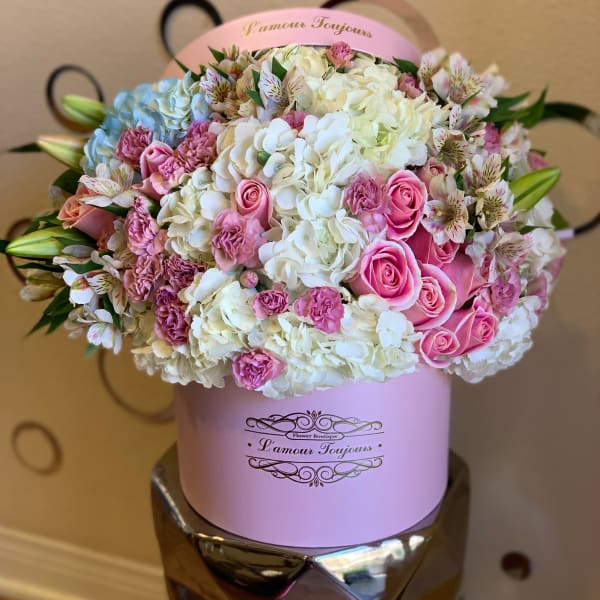 Pink and white bouquet in a round hatbox