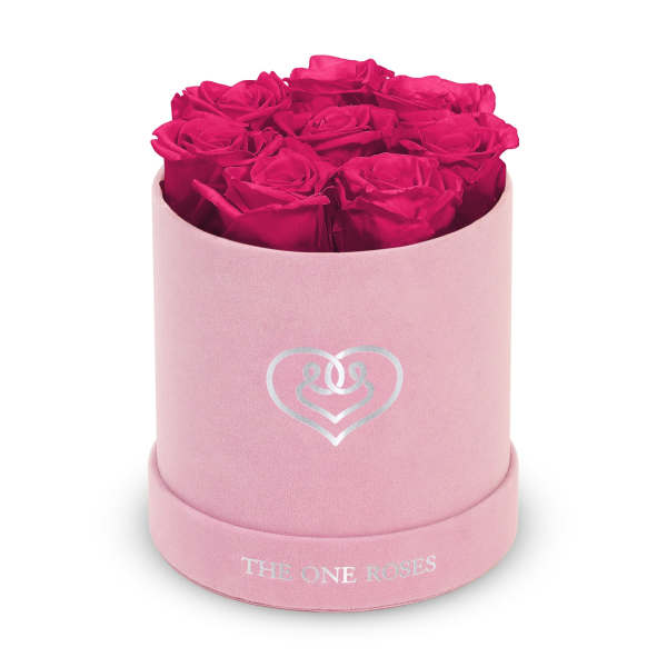Hot pink roses arranged in a pink round box