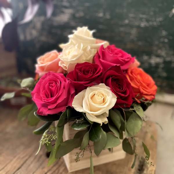 Bouquet of pink, red, and white roses in a square box