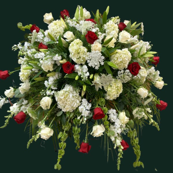 Large floral spray of red and white roses with white lilies and hydrangeas