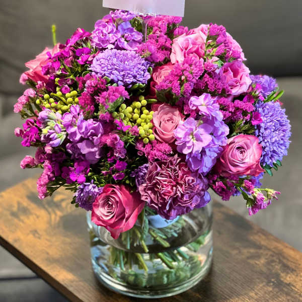 Pink and purple bouquet in a clear glass vase