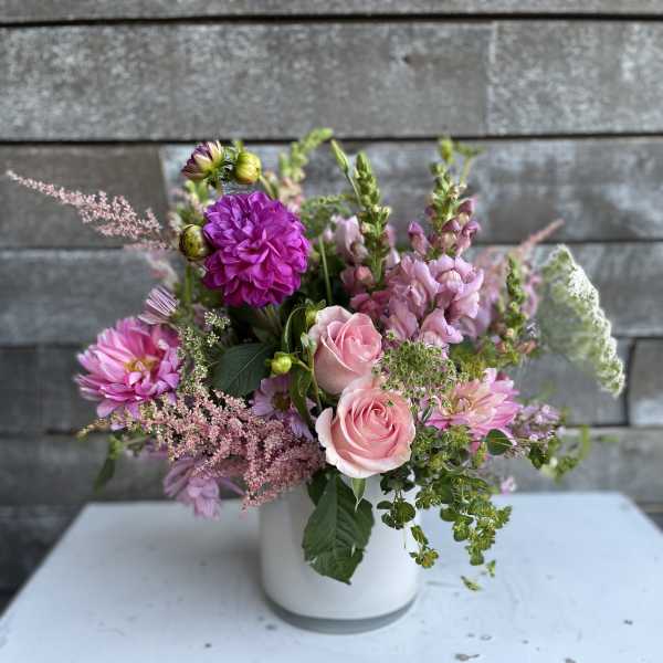 Pink and purple mixed bouquet in a white vase