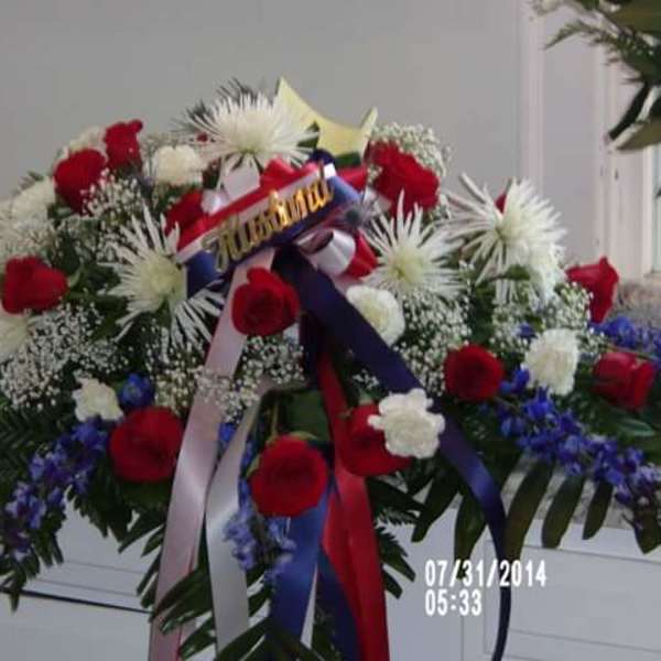 Large red, white, and blue floral spray with ribbons