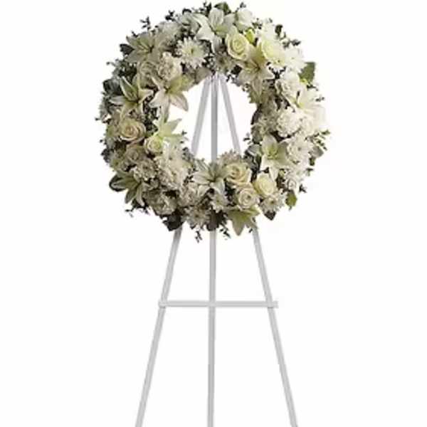 White floral wreath on a standing easel