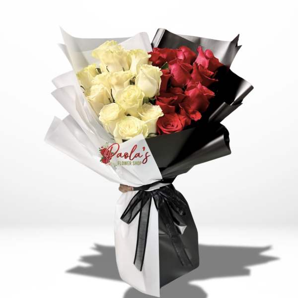 Bouquet of red and cream roses wrapped in black and white paper