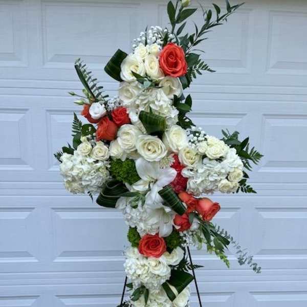 Cross-shaped floral standing spray with white and coral roses