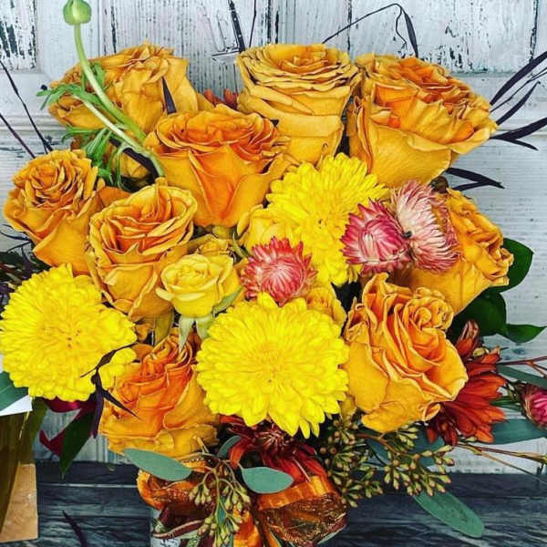 Bouquet of yellow and orange roses with bright yellow mums