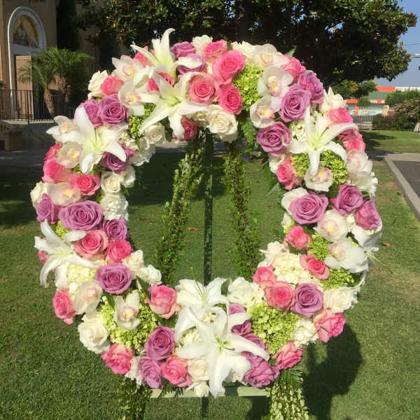 Large floral wreath of pink and white roses with white lilies