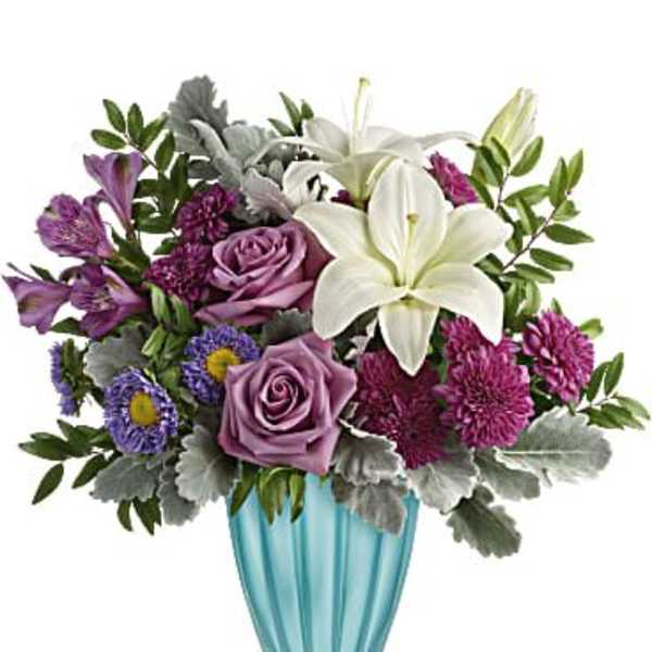 Purple and white flower arrangement in a blue glass vase