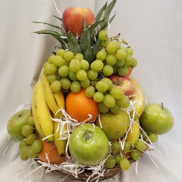 Fruit basket with grapes, bananas, apples, oranges, and pears