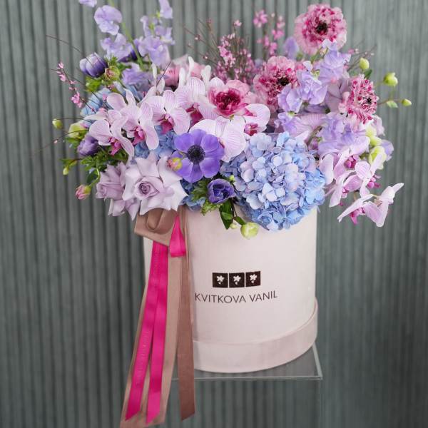 Lavender and pink flower arrangement in a white hat box