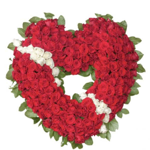 Heart-shaped wreath of red and white roses in a dense arrangement