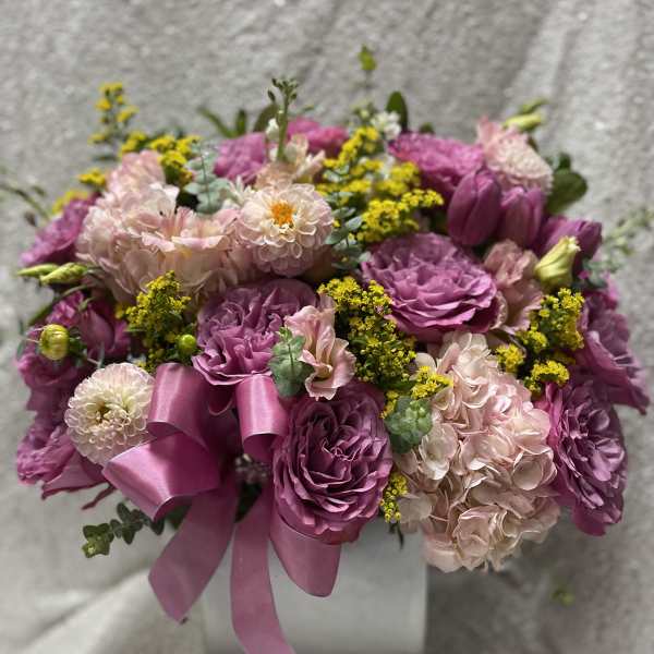 Pink and purple bouquet with a satin ribbon in a box