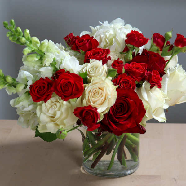Bouquet of red and white roses in a clear glass vase