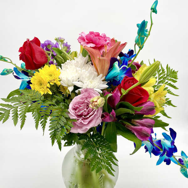 Mixed bouquet of colorful flowers in a glass vase