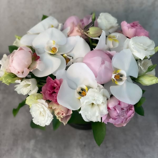 Bouquet of white orchids and pink flowers in a low arrangement