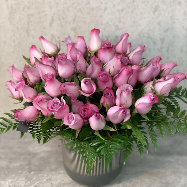 Pink rose bouquet in a ribbed gray vase