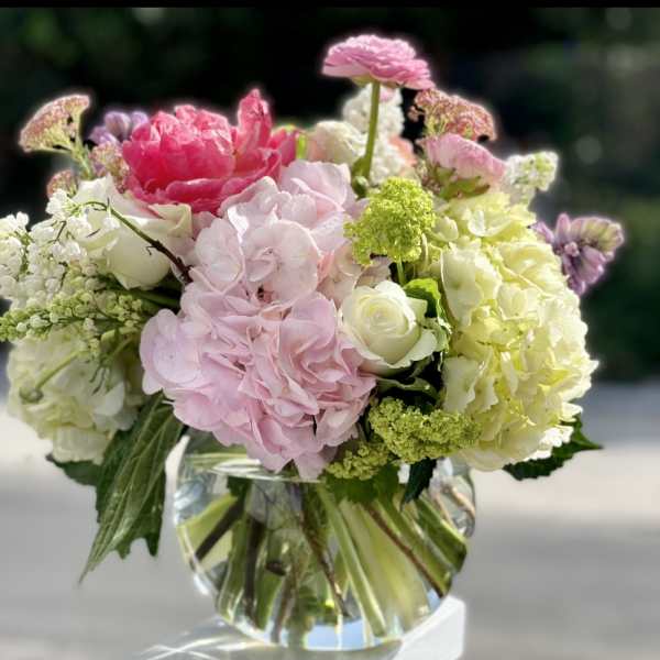 Pink and white floral arrangement in a clear glass vase