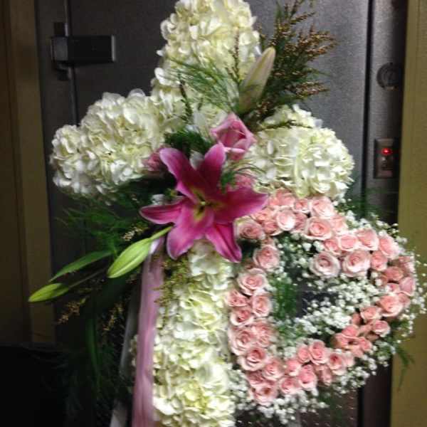 Standing floral spray with white hydrangeas, pink roses, and a pink lily