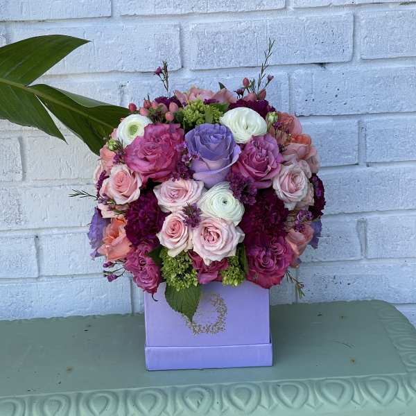 Pink, purple, and white rose bouquet in a lavender box