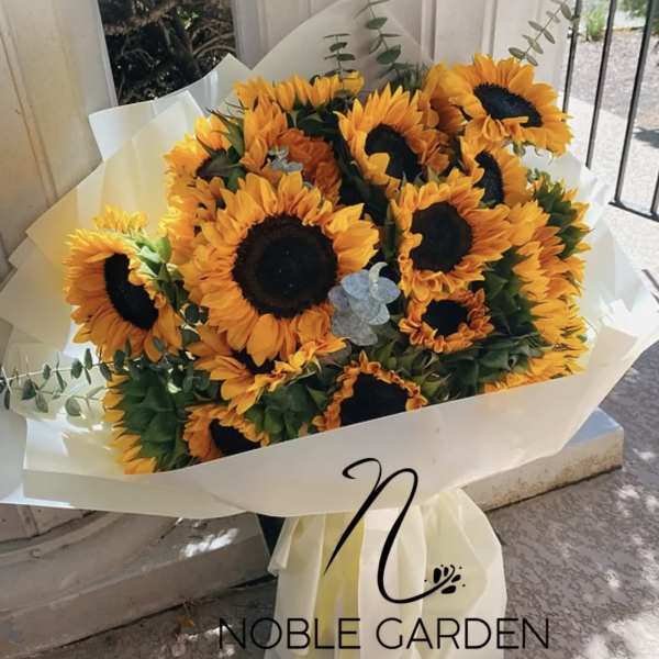 Bouquet of sunflowers wrapped in white paper