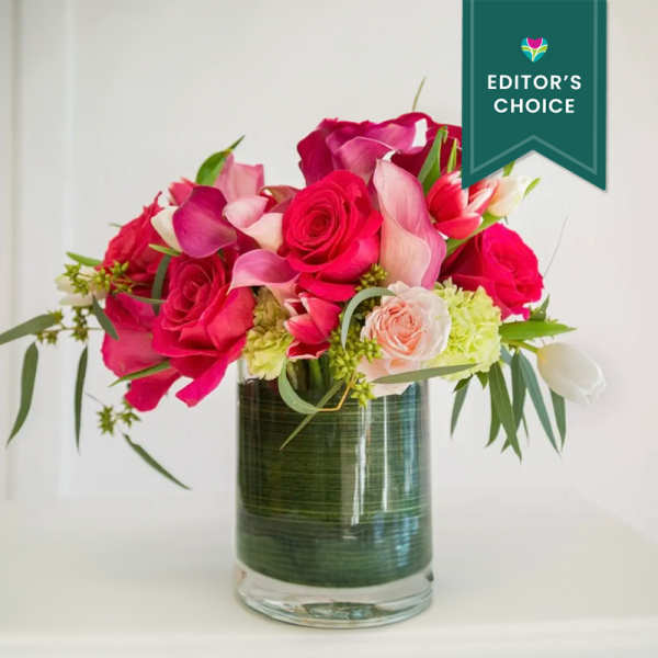 Pink and white floral arrangement in a clear glass vase
