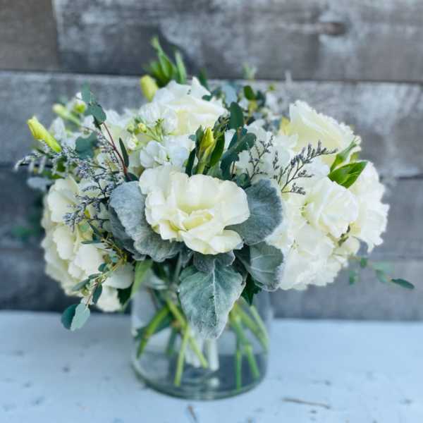 White floral bouquet in a clear glass vase