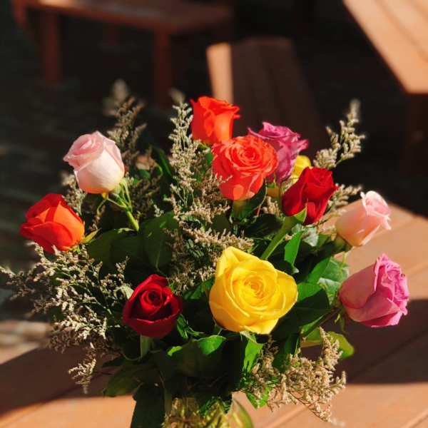 Bouquet of multicolored roses in a clear glass vase