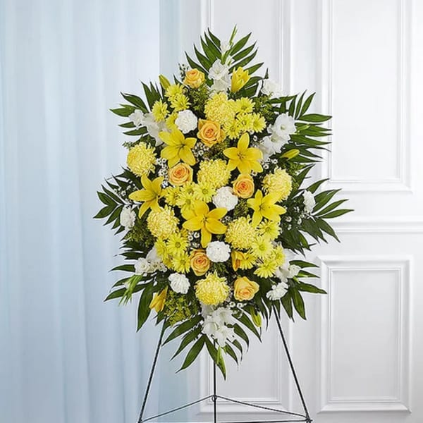 Yellow and white floral standing spray on an easel