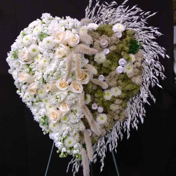 Heart-shaped white floral standing spray with roses and chrysanthemums